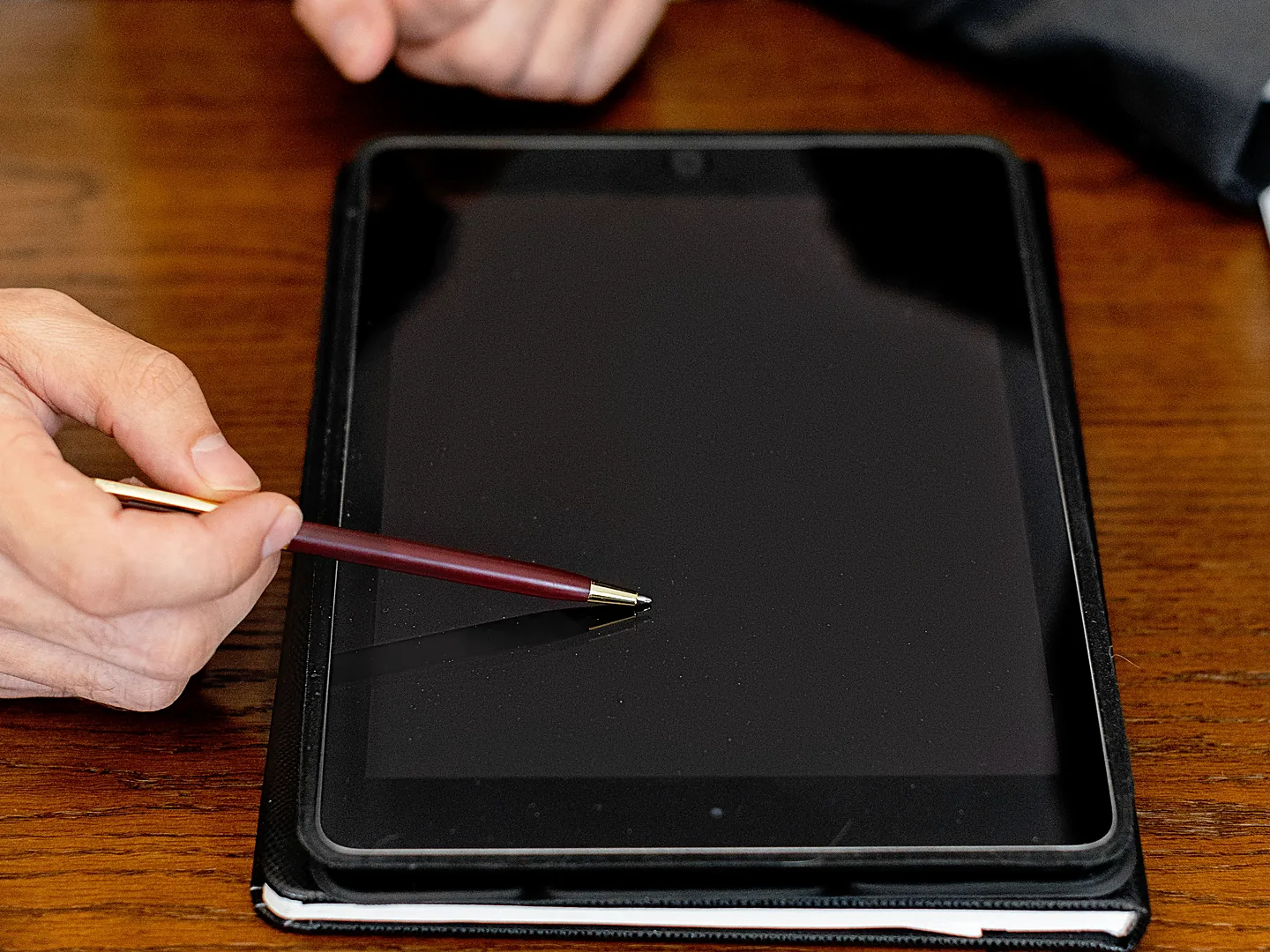 Business professionals using a tablet for a digital signature