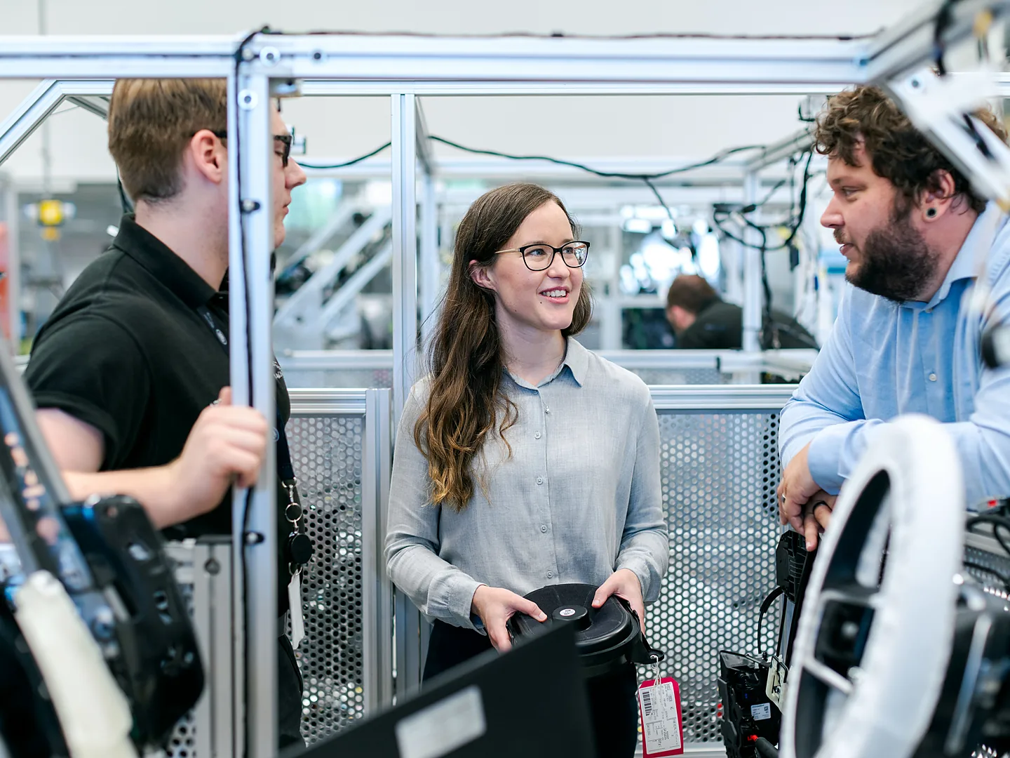 Engineers working with industrial machinery in a workshop