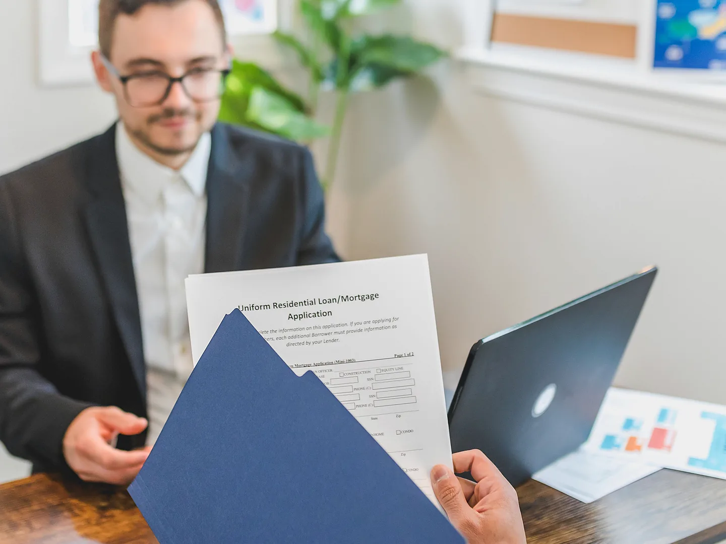 Loan consultant presenting application documents to a customer
