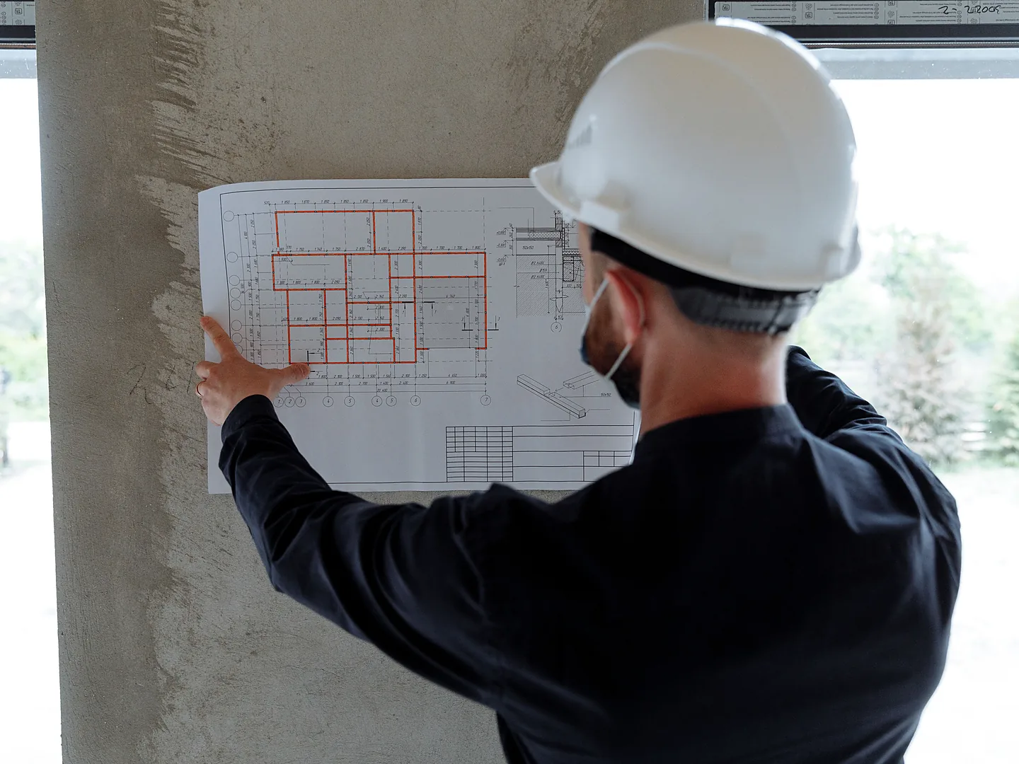 Engineer reviewing construction plans for project finance